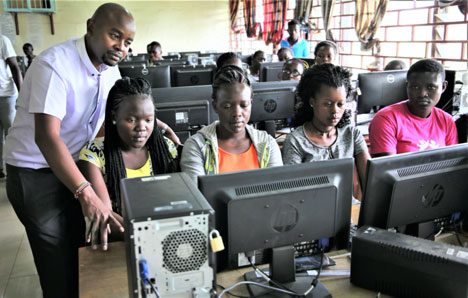 Head of ICT section Mr. Omariba assisting Basic-level students during their practical sessions
