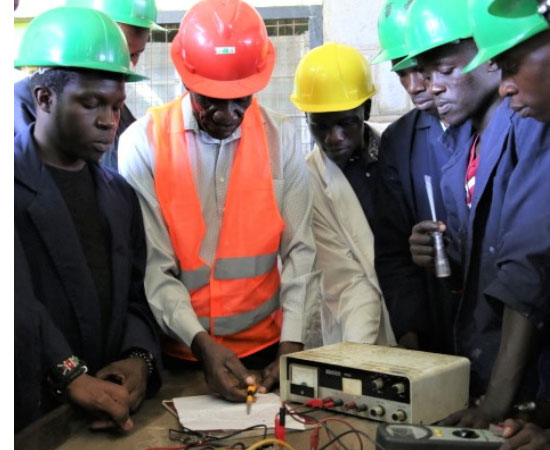 Advanced electronic students during a practical session with their instructor