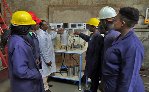 Mr. Kamunge illustrates how industrial boilers operates using the Boiler Simulator during a practical session with the Advanced Level students
