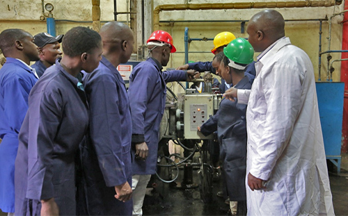 Basic Level students operating a diesel-fired boiler with the help of their instructor Mr. Mureithi